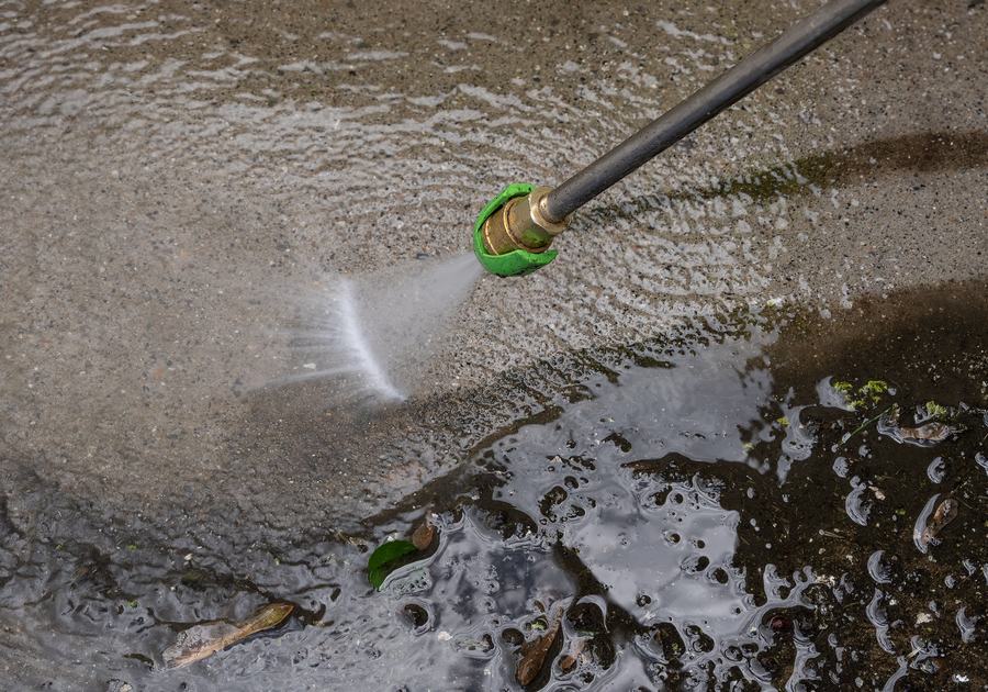 Pressure washing a concrete driveway