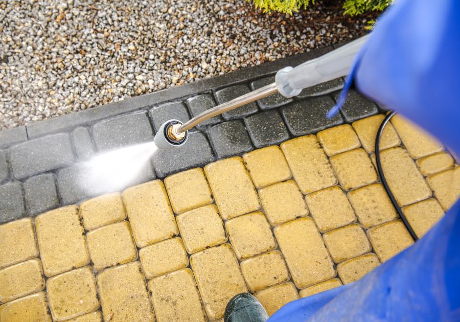 Pressure washing paver driveway back to clean stone
